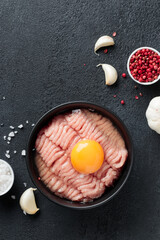 Cutlet ingredients poultry farce meat with egg in a plate