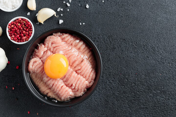 Cutlet ingredients poultry farce meat with egg in a plate