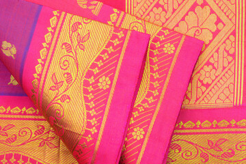 Pink silk sari with gold floral design background