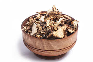 dried white mushroom slices in a wooden bowl on a white background.