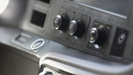 Modern car interior, details of dashboard. Scene. Close up of regulators of temperature or conditioner and volume on a dashboard of a new vehicle, transportation concept.