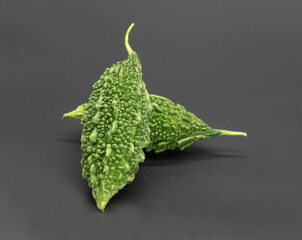 Bitter melon or Bitter gourd isolated on black background