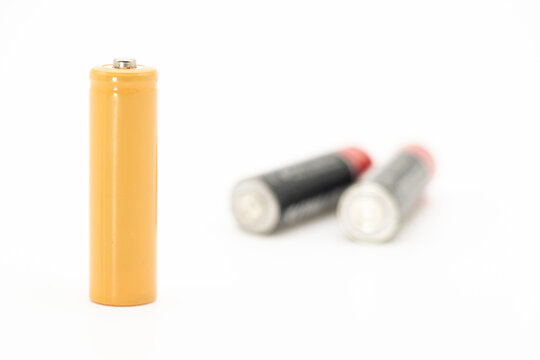 yellow AA size batteries isolated on white backgraound, selective focus