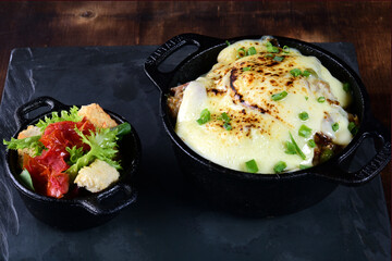 delicious pan of meatballs with sauce and cheese, with toasted bread and spices tasty food, vegetable salad