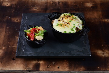 delicious pan of meatballs with sauce and cheese, with toasted bread and spices tasty food, vegetable salad