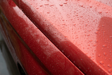 Raindrops on car. Red car is in details.