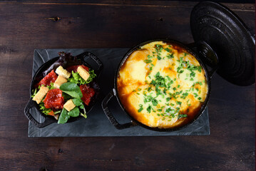 delicious pan of meatballs with sauce and cheese, with toasted bread and spices tasty food, vegetable salad