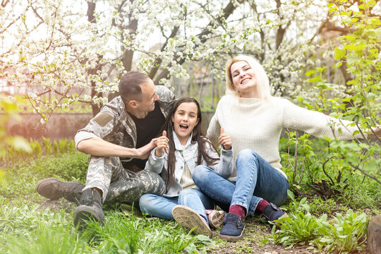 happy military family relaxing in the garden