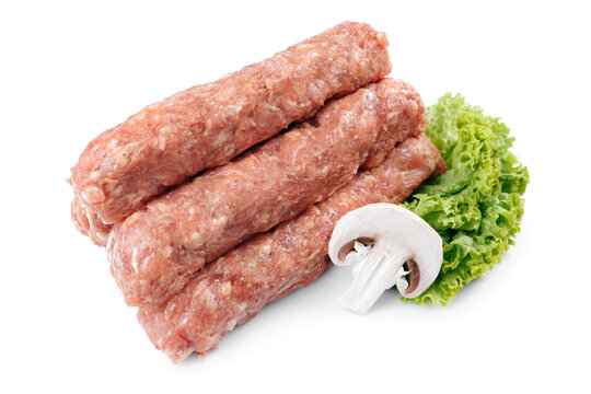 Raw traditional romanian meat rolls Mititei over white background.
