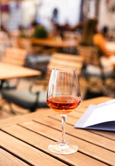 A glass of aperol on the table in a summer cafe on the terrace. Close-up.