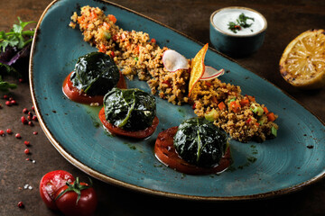 Hot salad with white sauce and balls green shrub on tomatoes 