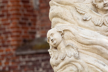 Putto (Putti) among the clouds - lower fragment of a rococo statue - Our Lady next to the Church of St. Stanisław in Nowy Korczyn, Poland