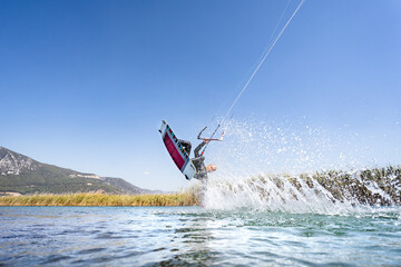 Water sports athlete having kitesurfing session, Akyaka, Turkey