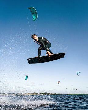 Extreme water sports athlete have kitesurfing session on windy day in Lithuania