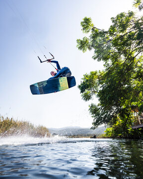 Kiteboarder in action jumping in the air doing extreme tricks, Akyaka, Turkey