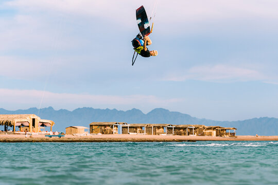 Kiteboarder doing stylish frontroll move with board grab, Blue Lagoon, Egypt