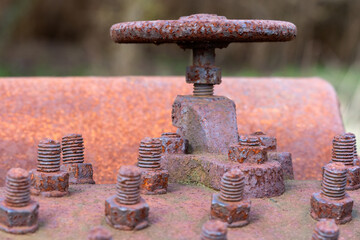 Fragment of an old, vintage, rusty chaff cutter (bolts, nuts and valve), Close-up, macro