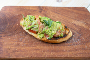 baguette slice toast with avocado paste, tomato and spring onion