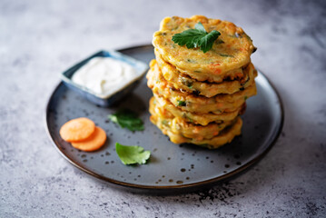 Corn fritters with carrots and parsley