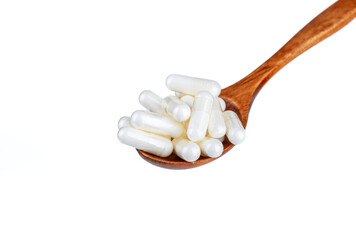 Fototapeta na wymiar Wooden spoon with vitamin D3 capsules or dietary supplement or medicine over white background.