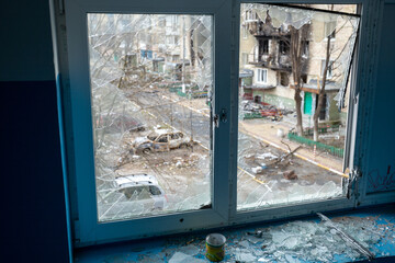 War between Russia and Ukraine. View from a broken window on a house damaged by shelling