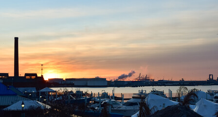 Morning breaking over Baltimore harbor as the sun rises against a colorful sky