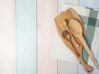 napkin with wooden kitchen utensils on wooden table, food recipes .copy space