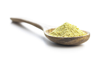 Ground green coffee in wooden spoon. Unroasted coffee isolated on white background.