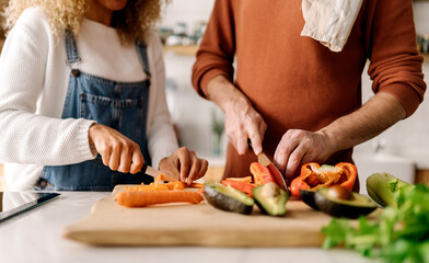 Obraz na płótnie Canvas Couple preparing food in kitchen.