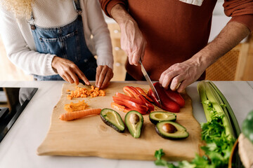 Couple preparing food in kitchen.