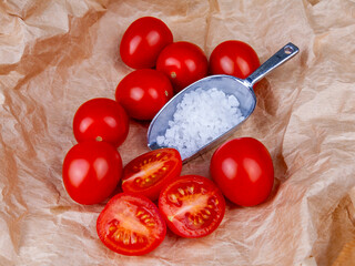 Fresh rape tomatoes on a table. and sea salt. Flat lay