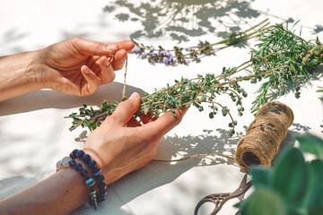 Alternative medicine. Collection and drying of herbs. Woman holding in her hands a bunch of...