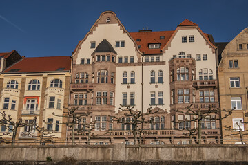 Fototapeta premium Beautiful traditional medieval buildings along the picturesque river Rhine promenade at sunset. DUSSELDORF, GERMANY.