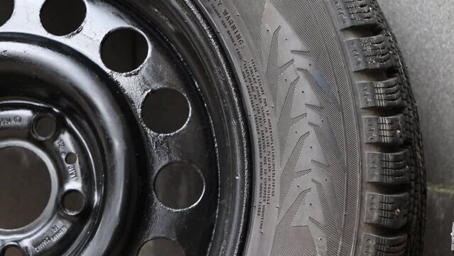 Used winter studded tire for car.Studded wheel for car close-up.