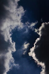 Fototapeta na wymiar dark blue cloudy sky with dark cumulonimbus clouds covering the sun