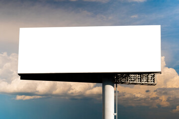 Blank wide white billboard against warm sunset sky with clouds - mock up. Consumerism, advertising, white screen, template, mockup and copy space concept - obrazy, fototapety, plakaty