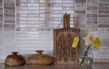 Wooden utensils, narcissus flower kitchen background