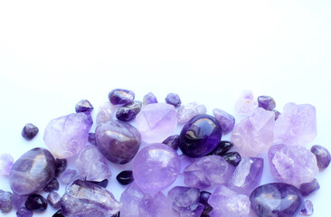 Gemstone minerals on a white background. Round tumbling minerals of amethyst and amethyst crystal.