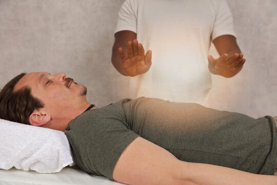 Man having energy healing treatment , alternative medicine, holistic care concept.