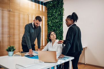 Multicultural team working together in office and having a meeting
