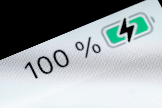 Smartphone full charged pixel battery level indicator - charging process - one hundred, 100 percent: close up macro view of gadget display, screen. Energy, technology, power, digital, symbol concept