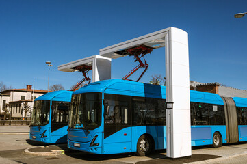 Electric buses are in the parking lot on a charge. Eco-friendly urban public transport