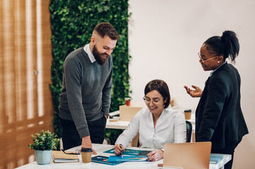 Multicultural team working together in office and having a meeting