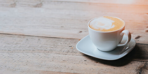 hot cappucino coffee cup on wood table banner