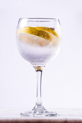 gin tonic glass with lemon slices on white background