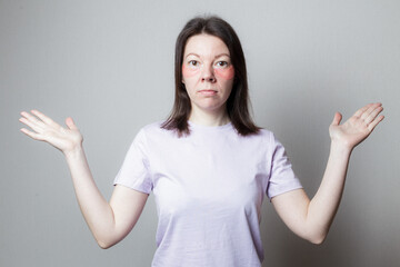 beautiful girl makes a cosmetic procedure. The girl uses eye patches. Skin care under the eyes. woman throws up her hands.