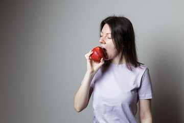 young woman eats an apple. The concept of healthy teeth.