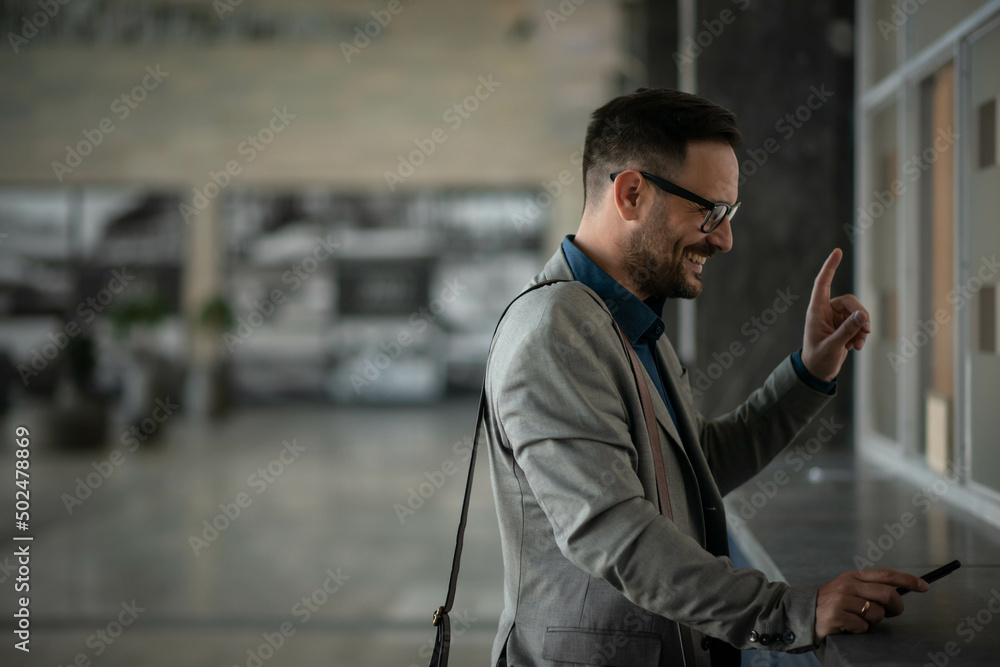 Wall mural Businessman buying ticket on train station. Asking for price