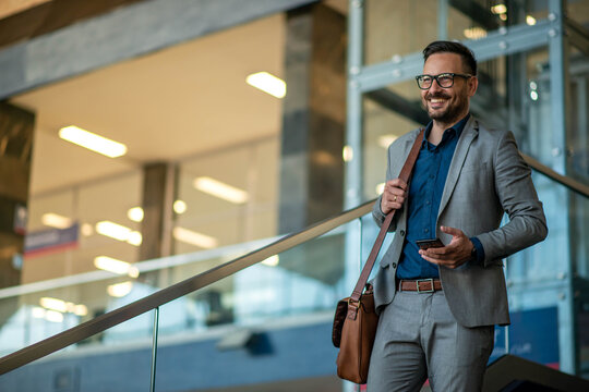Business man using phone and walking. Stock photo