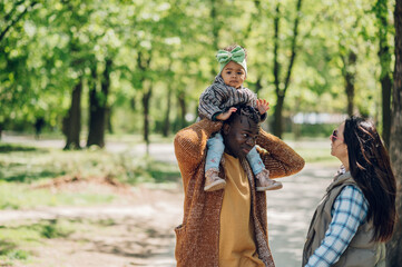 African american father and young daughter playing in the park